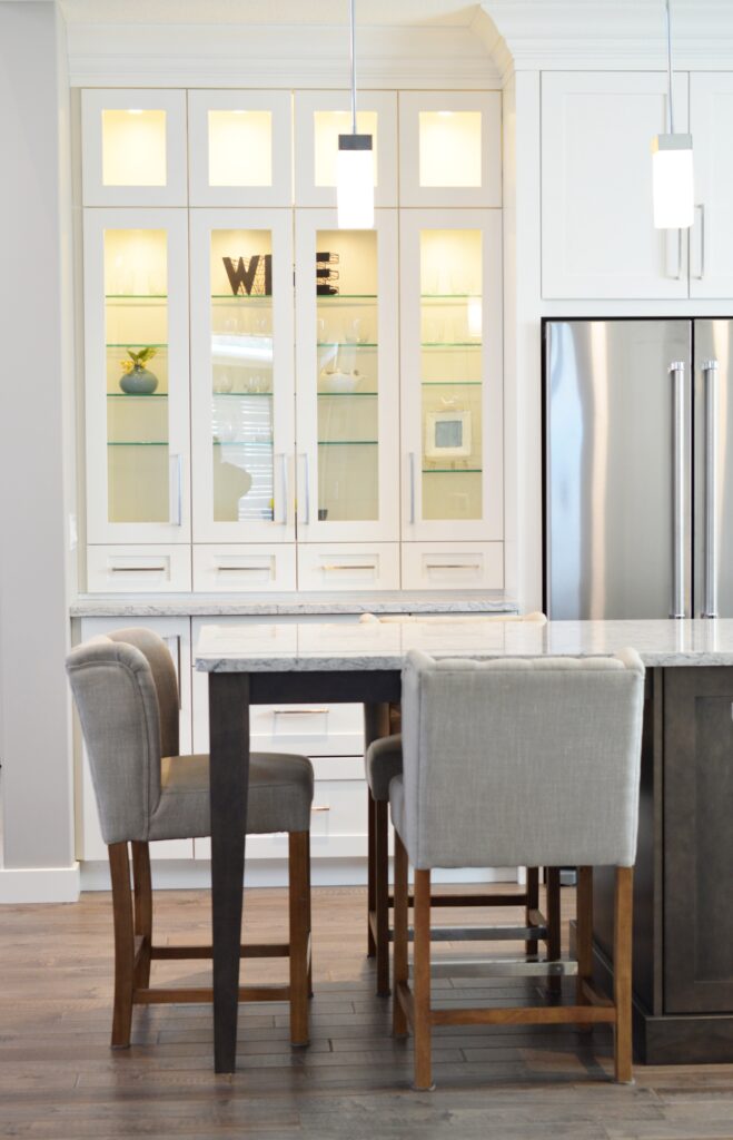 White kitchen remodel with custom lit built in cabinets